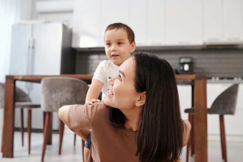 an asian mother and her son at the dining table