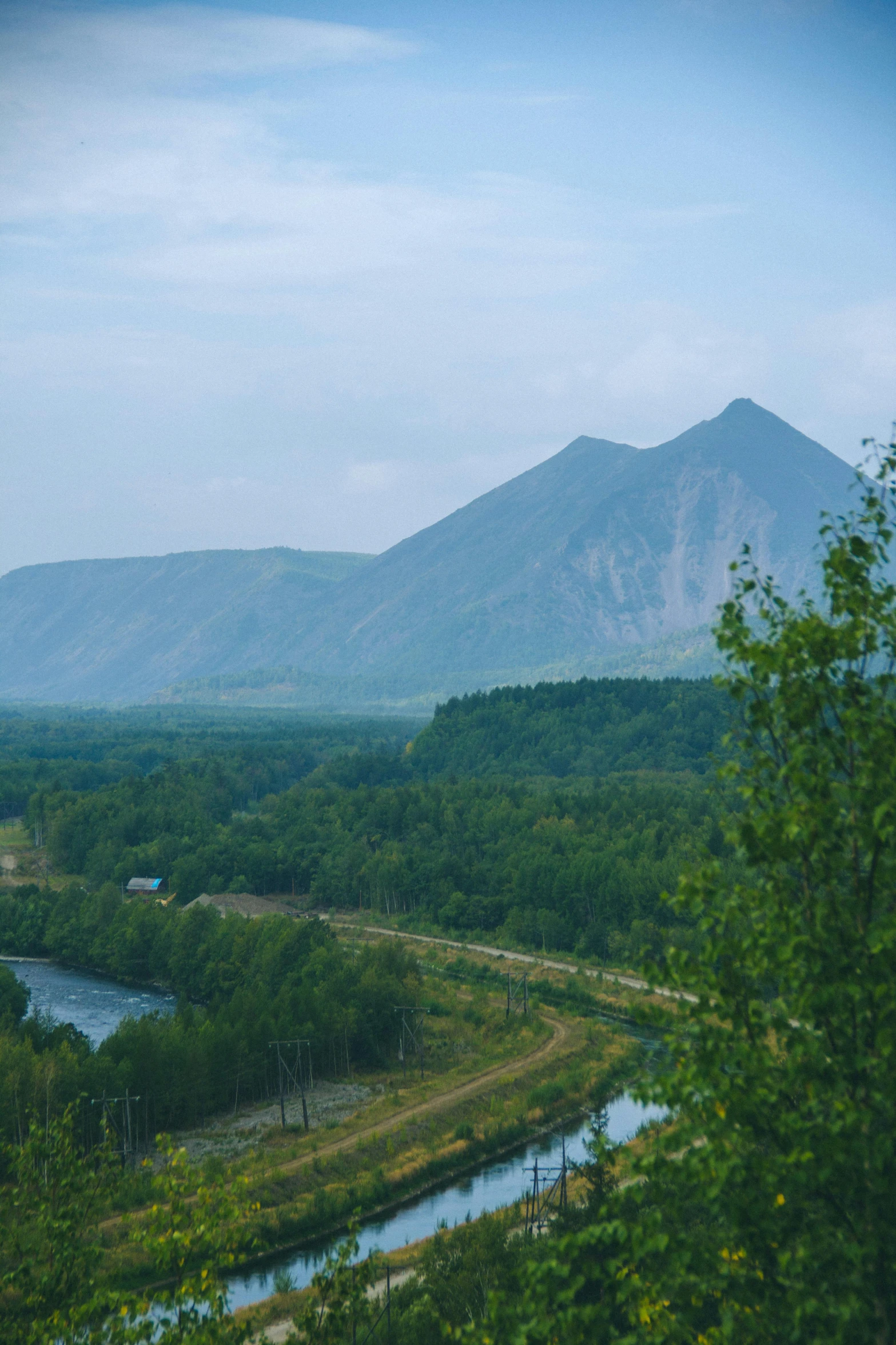 a po taken looking at mountains, trees and a river