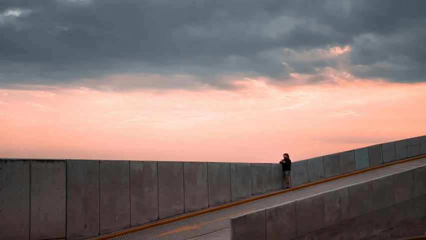 a person walking down a path at dusk