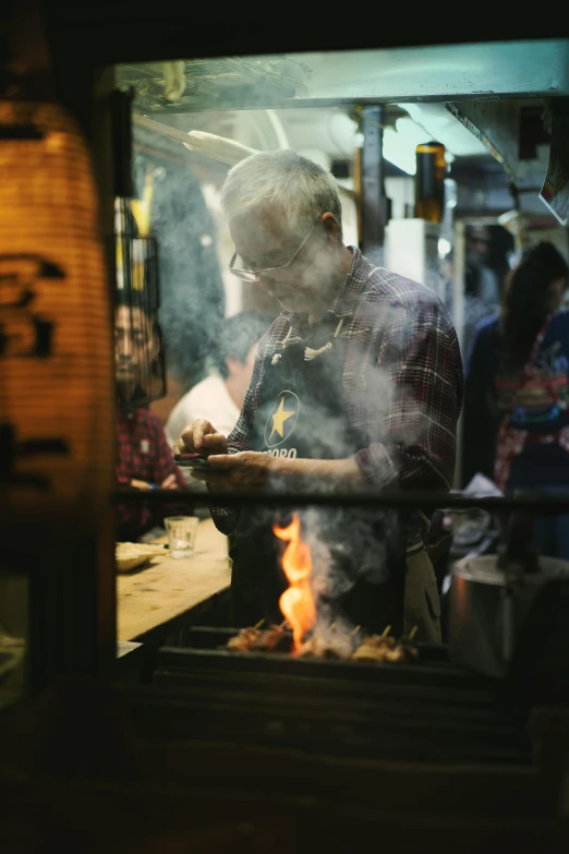 a man making food on top of a grill