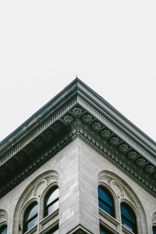 a corner of a very large building with a clock