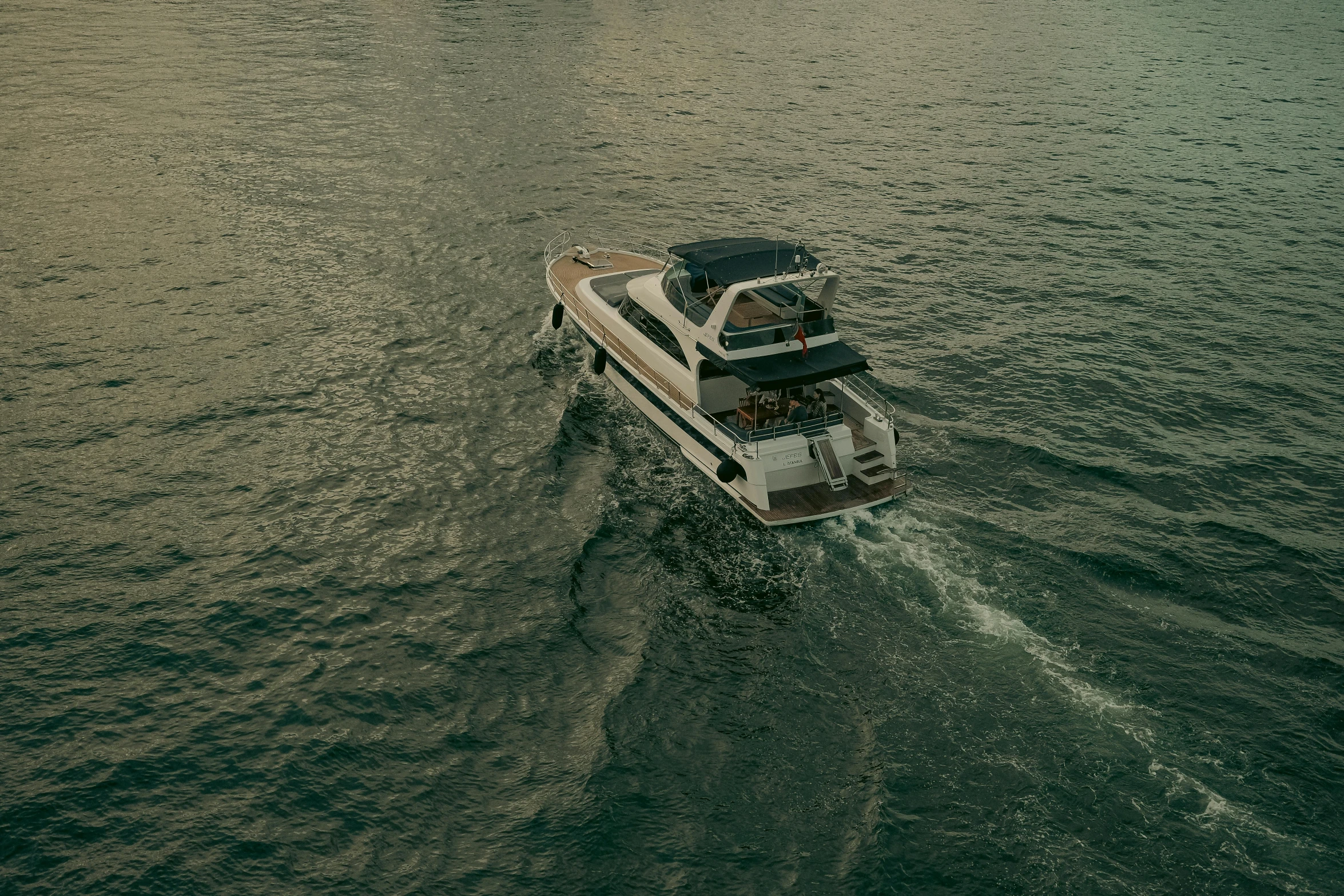 two boats with people on each boat in the water