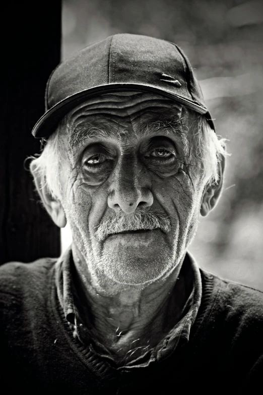 an older man with big eyes wearing a hat