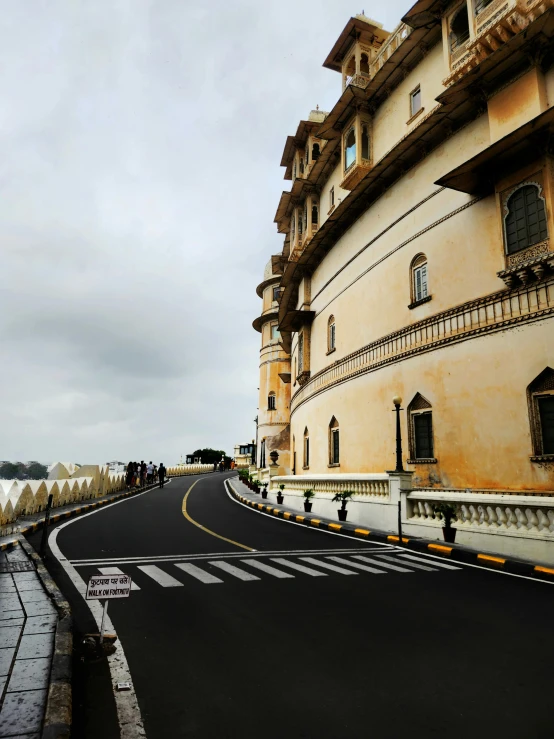 a winding road in front of a large building