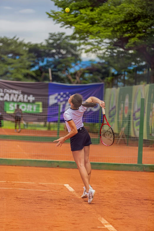 a woman is running to hit the tennis ball