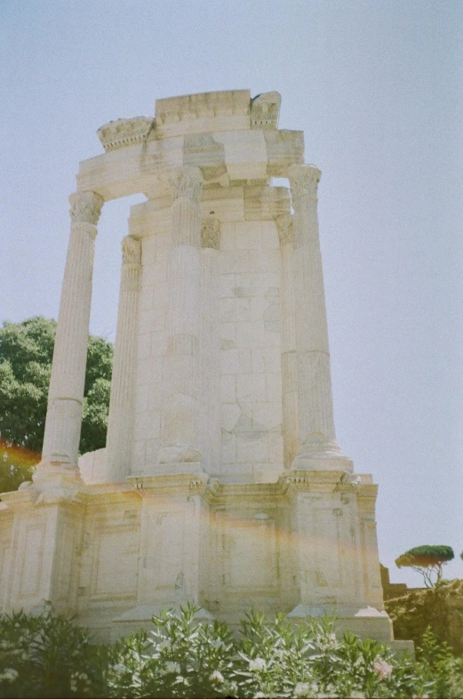 a white monument is shown on the side of the street