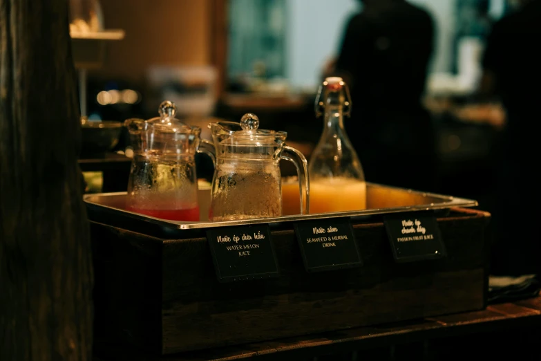 two glass bottles and some liquid in a holder