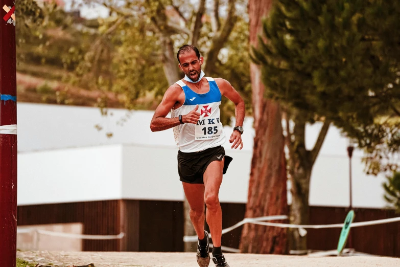 a person running in a marathon in front of a tree