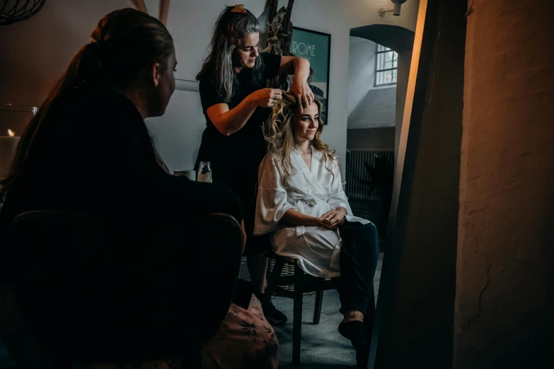 a group of women getting their hair done by a hair stylist
