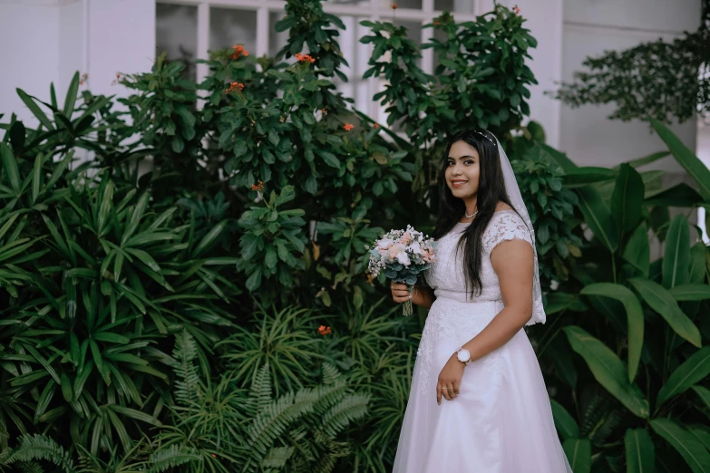 woman standing in front of tree and greenery at day