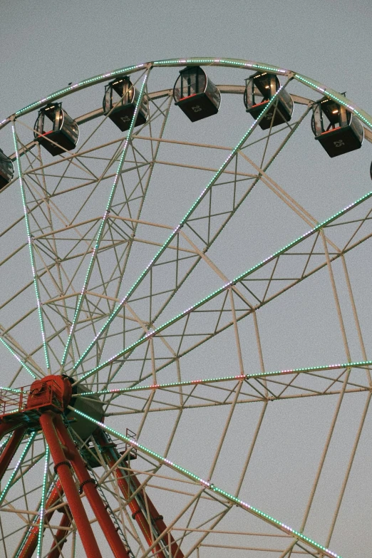 a ferris wheel has been lit by several street lamps