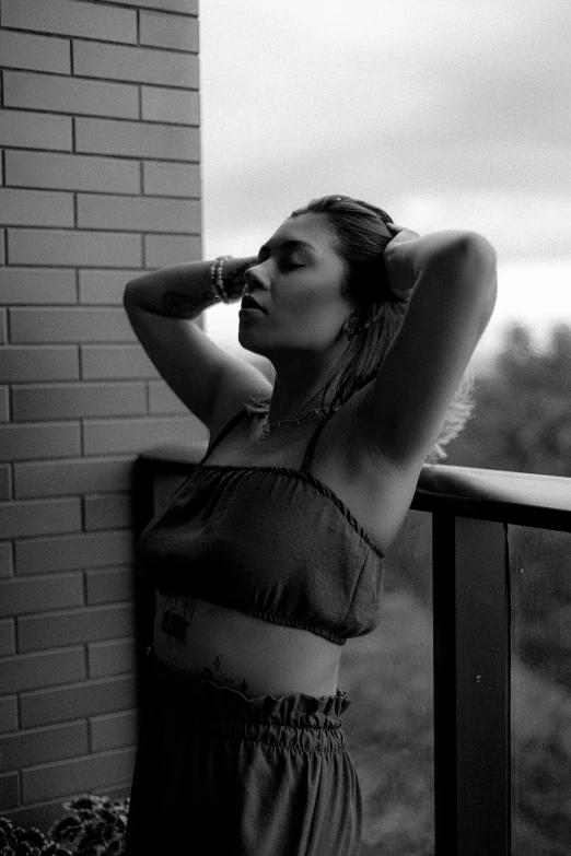 a woman in lingerie looking out a window on the side of a building