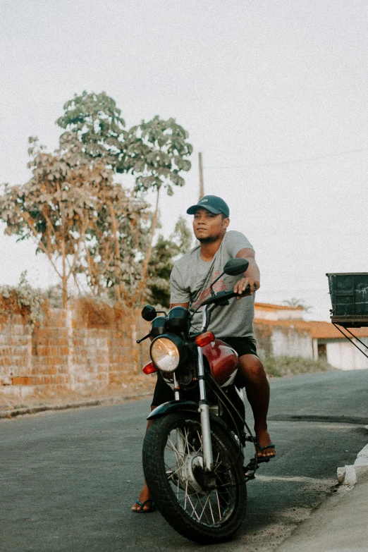 two guys riding a motorcycle on the road