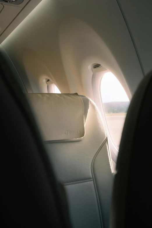 the interior of an airplane with two pillows and a plane window