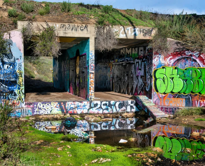 a bunch of colorful graffiti on the side of a building