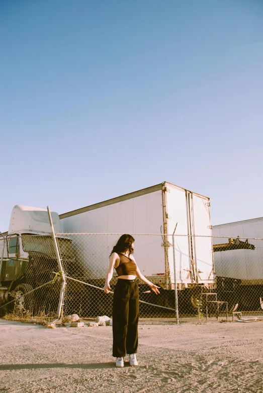 a woman is standing in the middle of a parking lot