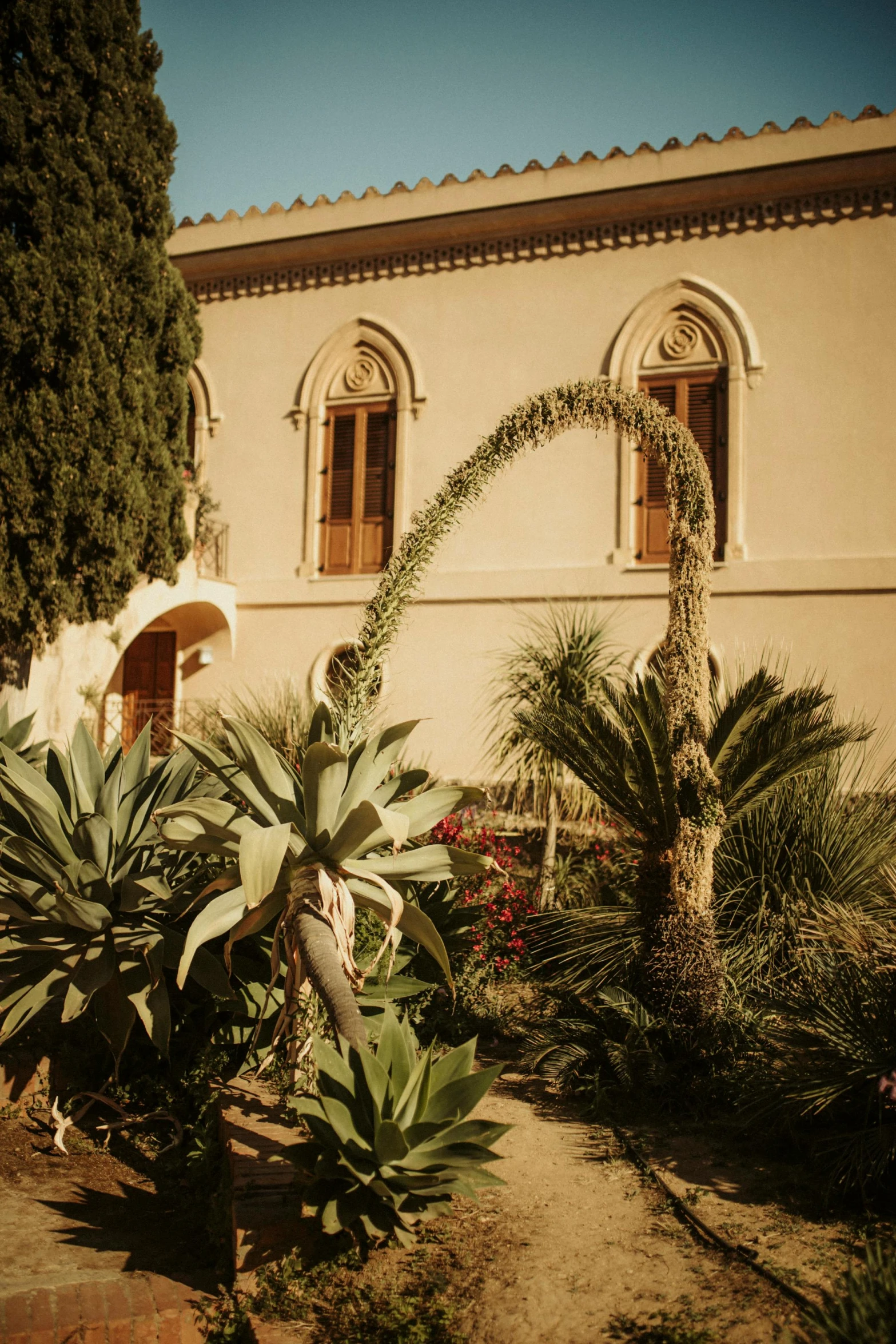 a house that has an ornate looking archway outside of it