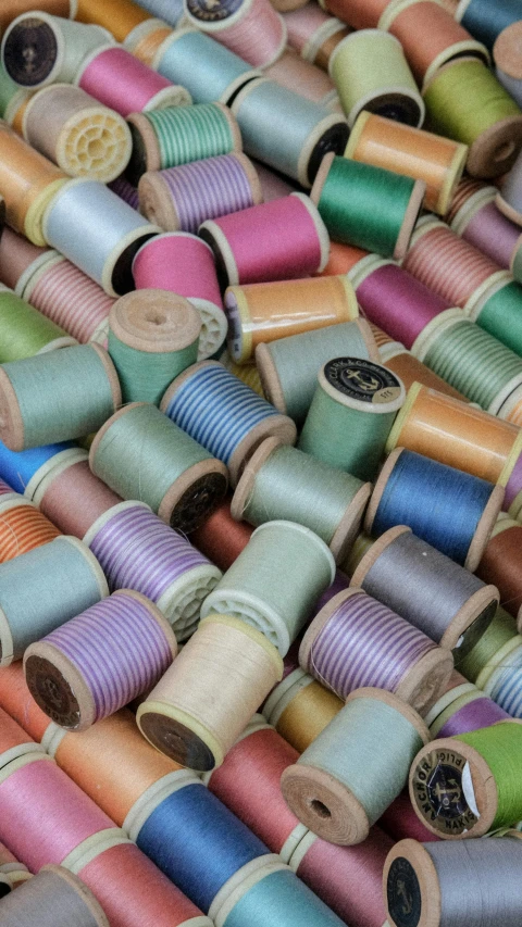 spools of thread that are colored and are sitting together