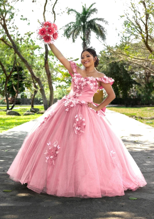 woman in pink dress with flowers posing for a picture