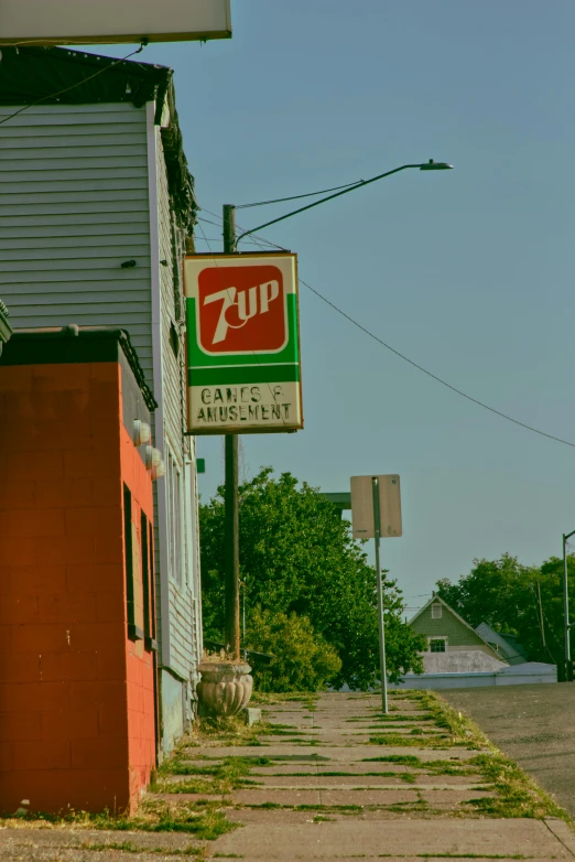 a tan and green sign advertising a restaurant