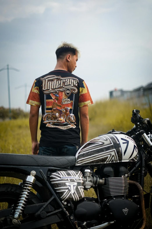 a man wearing motorcycle gear standing next to a motorcycle