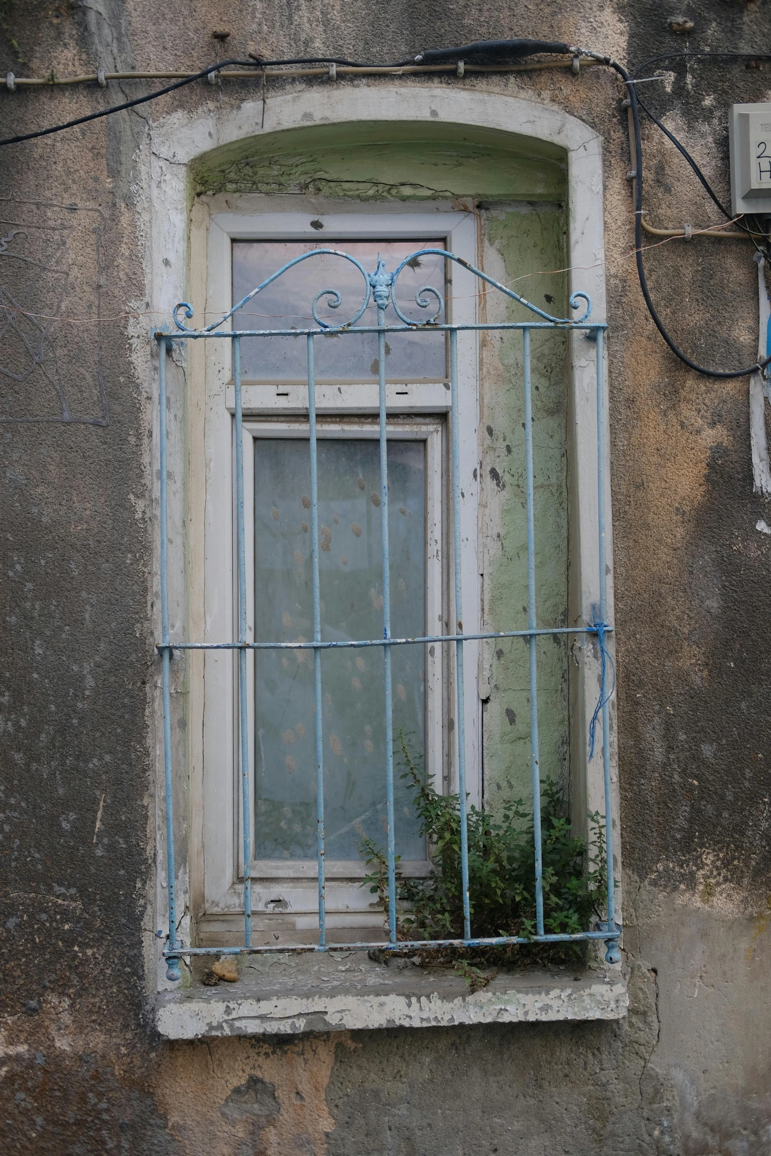 a window with wire hanging off the side