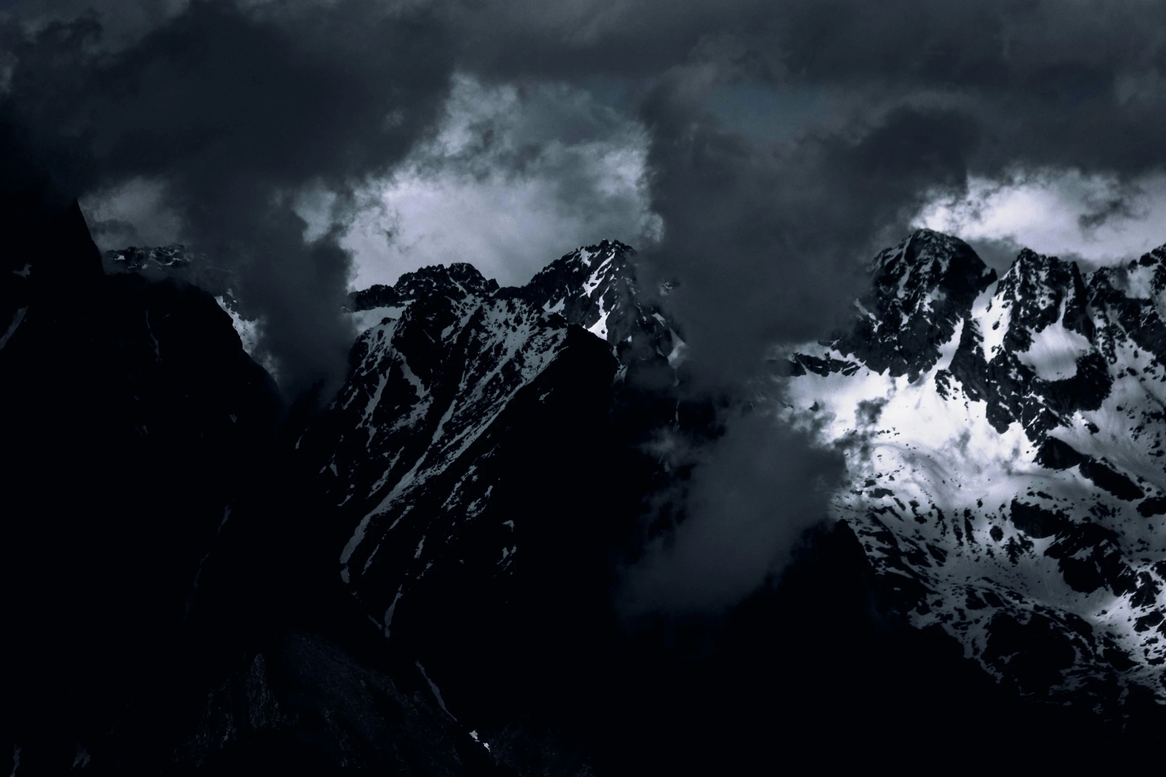 some mountain covered in clouds and snow