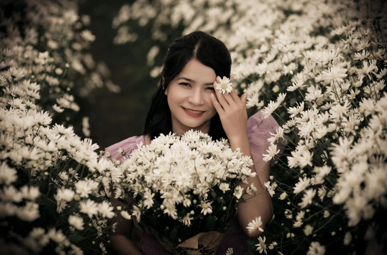 woman with flower bouquet in foreground holding white flowers