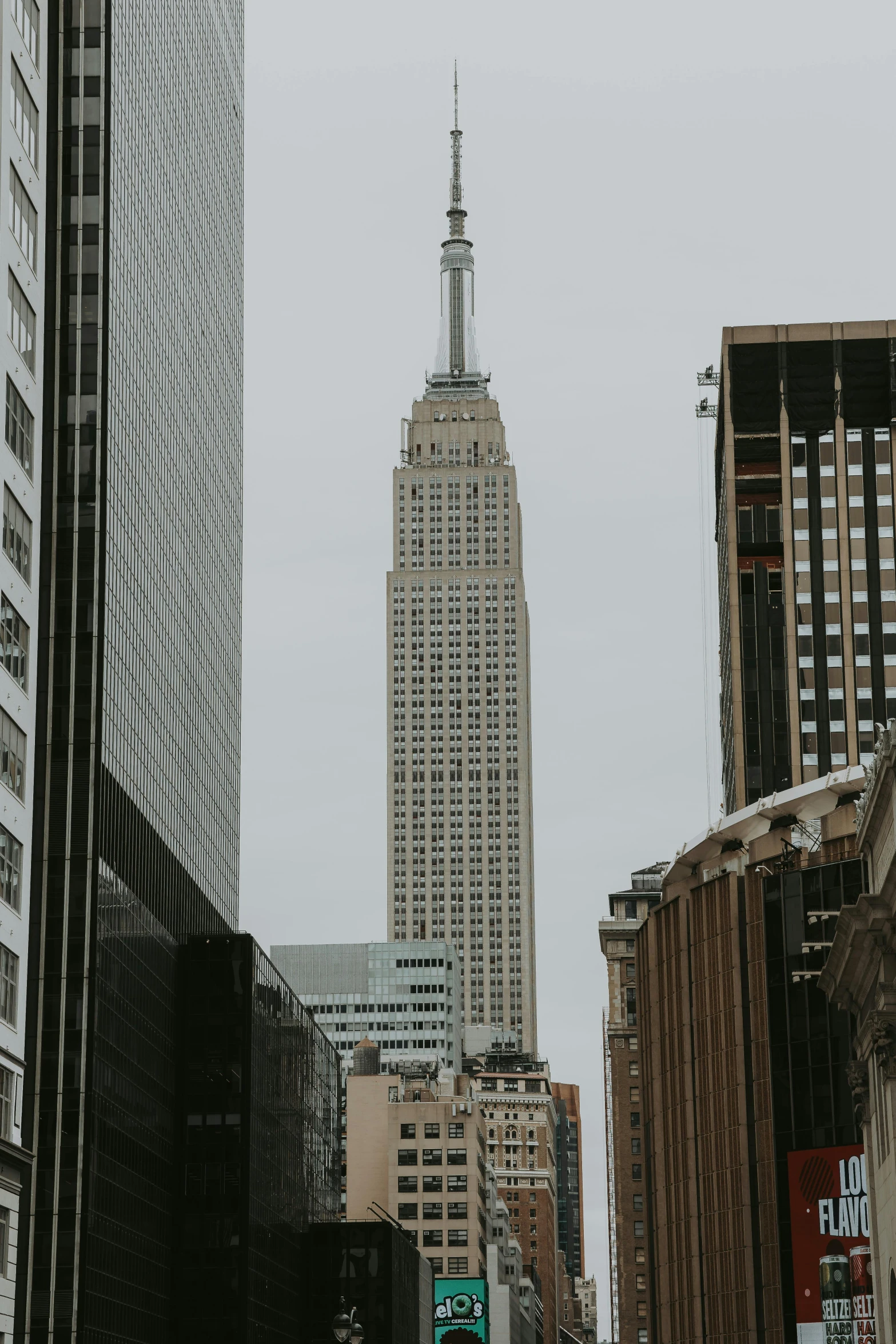 view of an urban building next to a bridge with skyscrs in the background