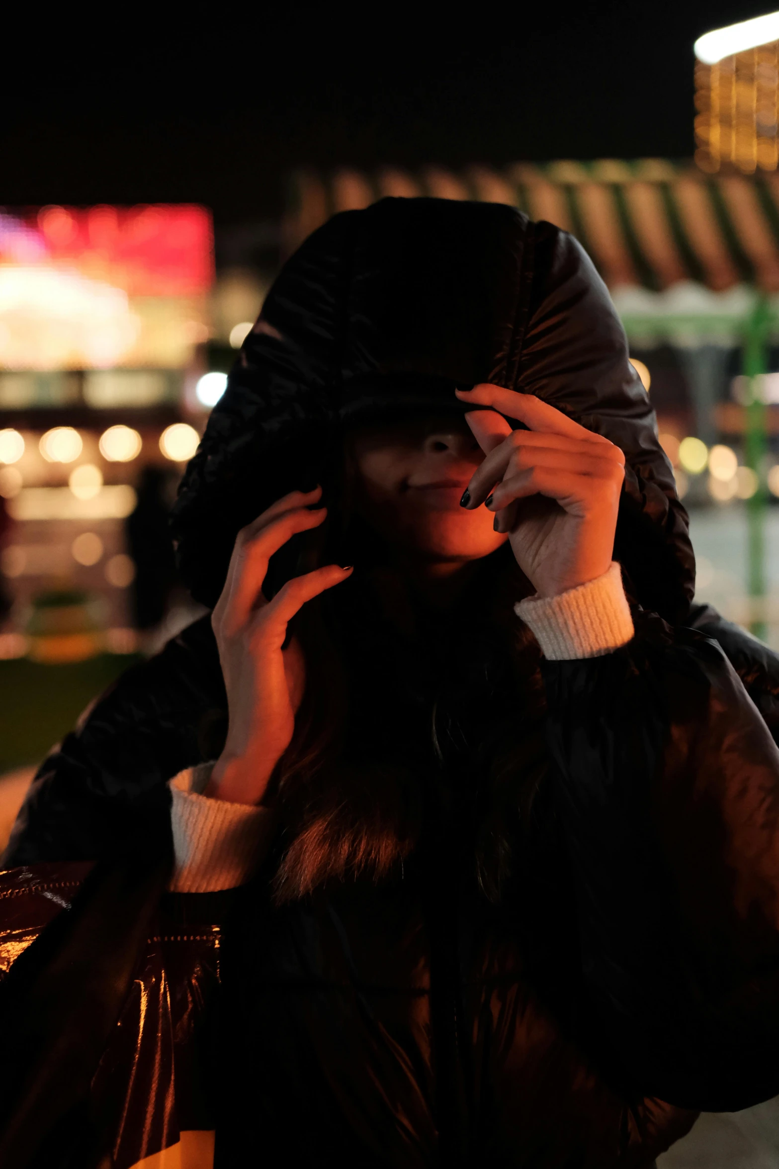 a woman talking on her cell phone while holding a handbag