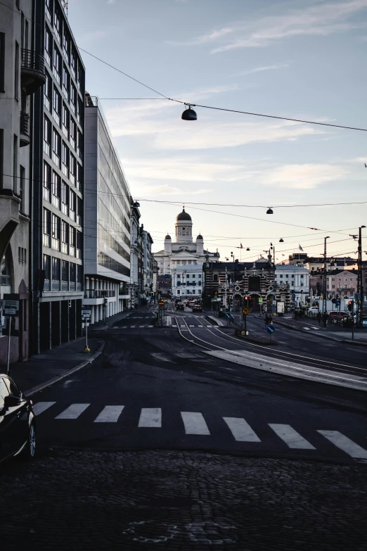 a dark city street with a tram on one side