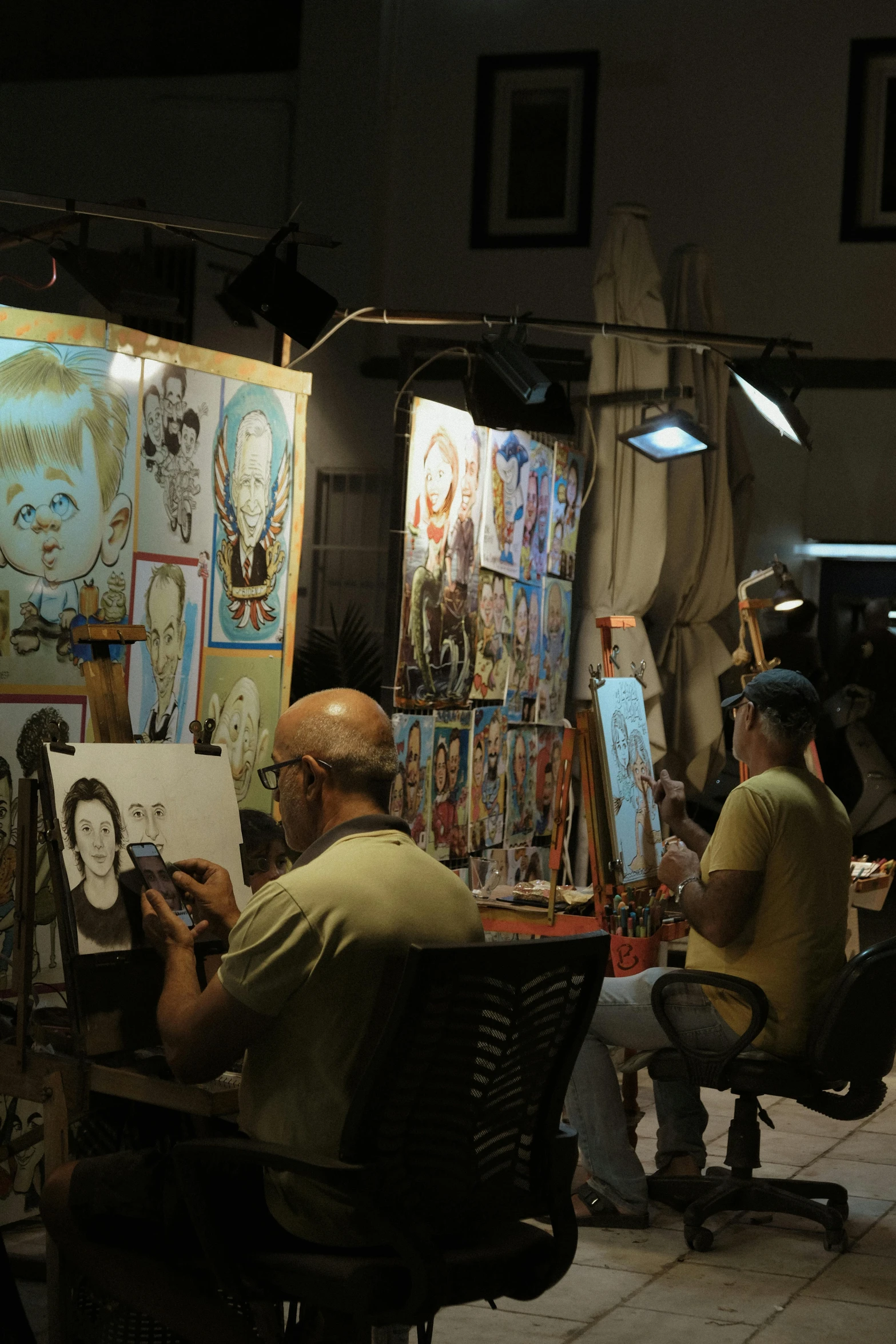 a group of people sitting around a table with art on it