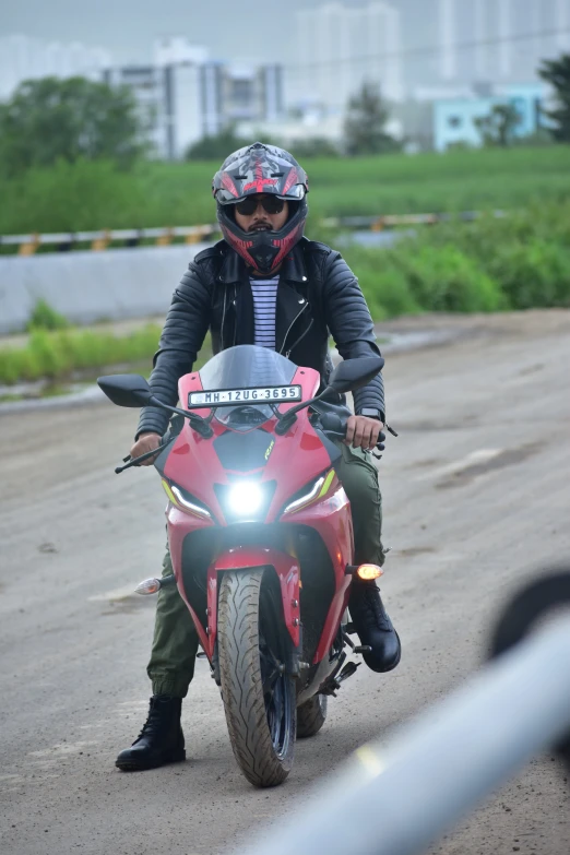 a person on a motorcycle, making its way through a street