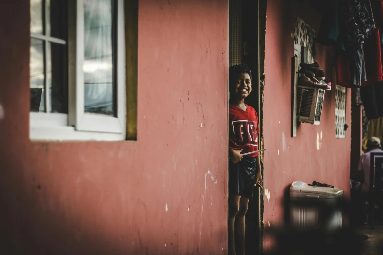 a  peeking out the side of a building through an opening