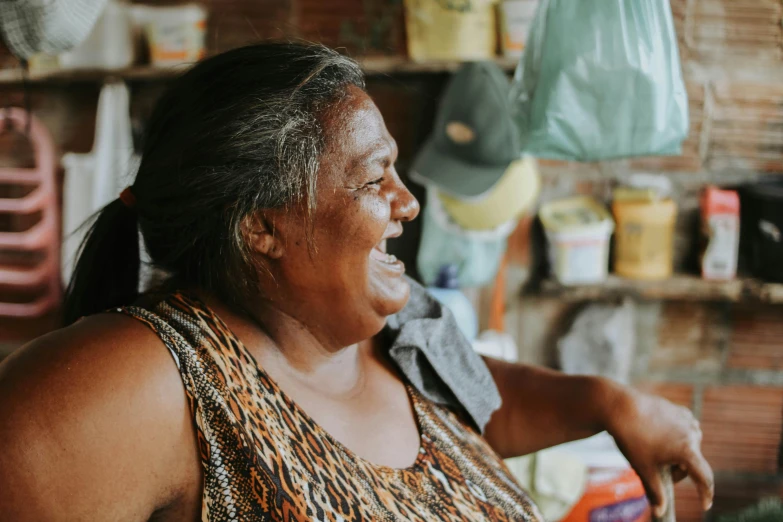 an elderly woman sitting in front of a bunch of food