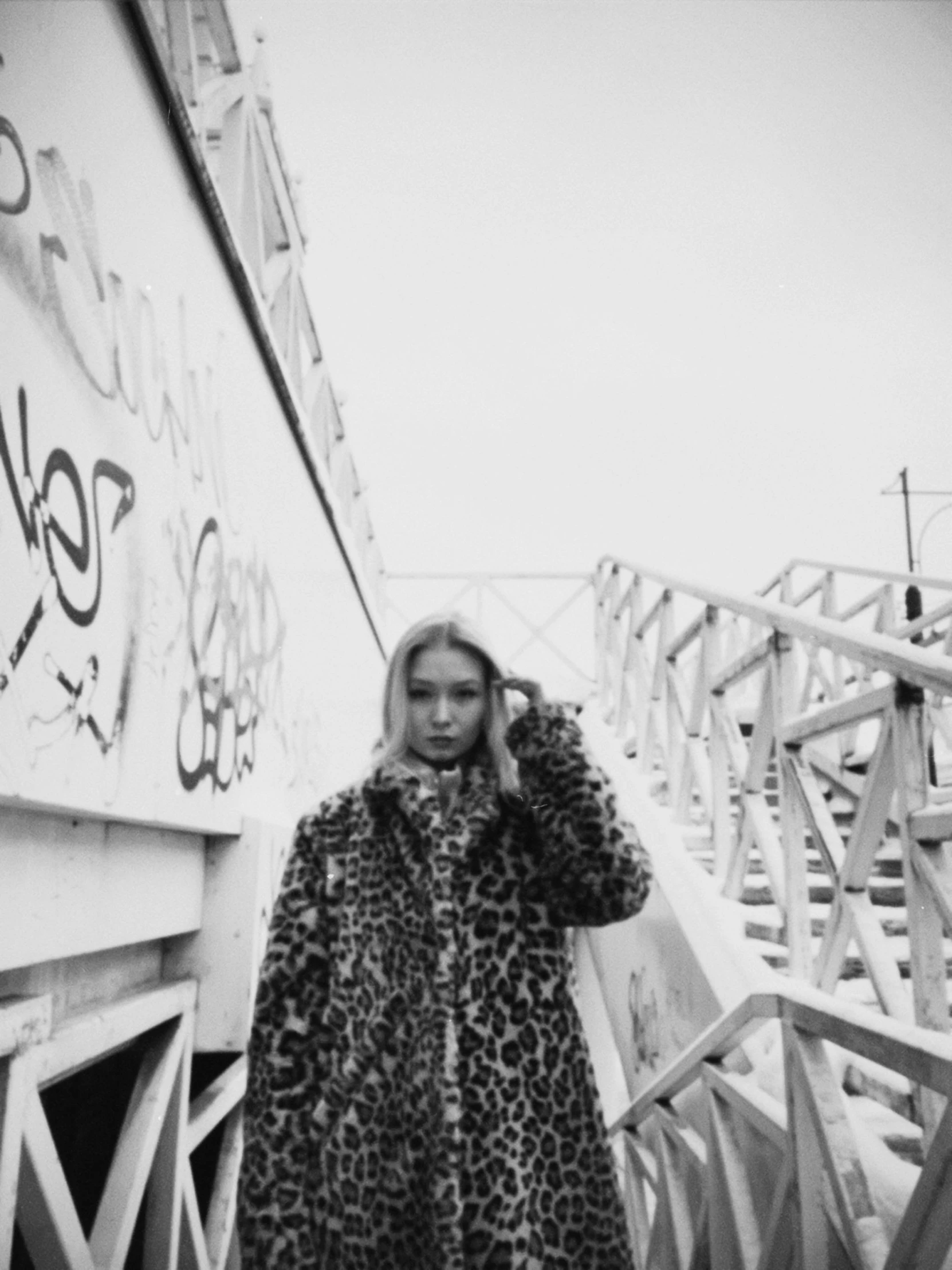 black and white pograph of a girl in an animal print coat