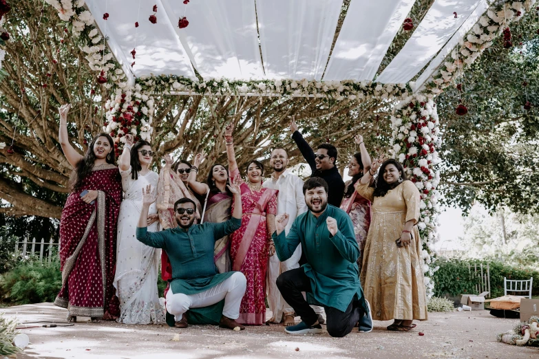 a group of people that are underneath a wedding arch