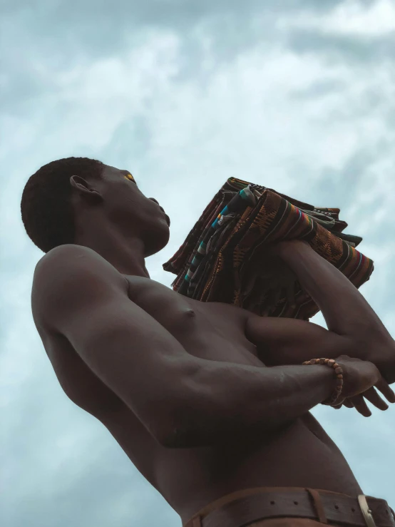 a man holding a cloth up against the sky