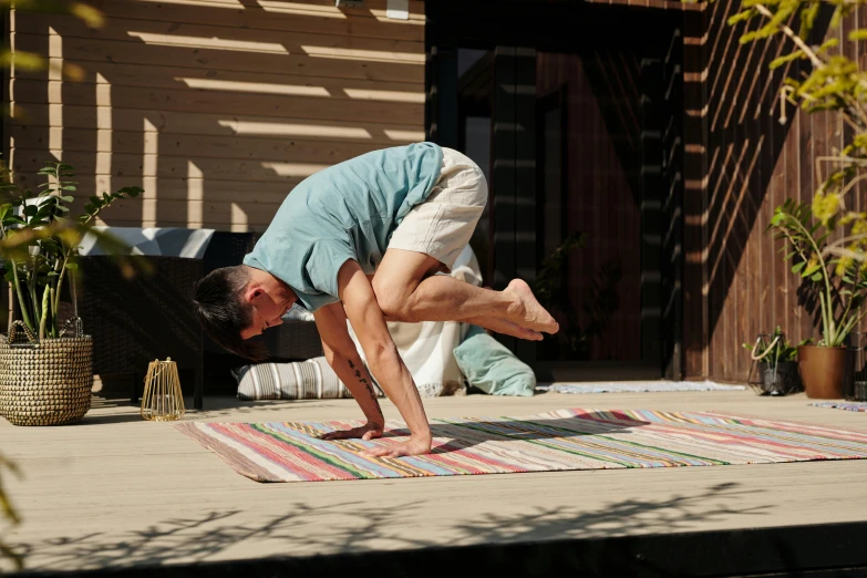 man on rug looking into the ground while standing