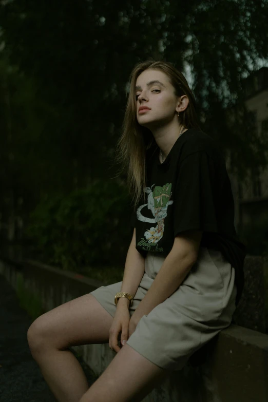 a girl sitting down on a concrete wall