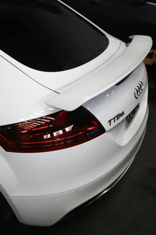 the back of a white sports car in a showroom