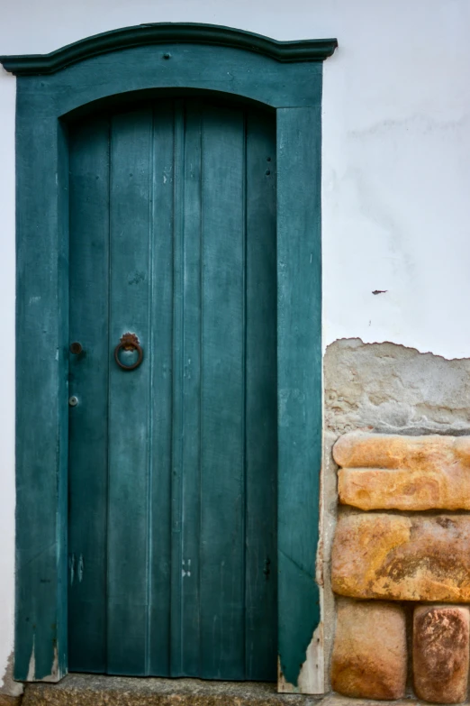 a tall blue door is in the doorway