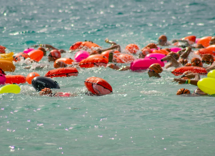 a group of people are swimming in the water