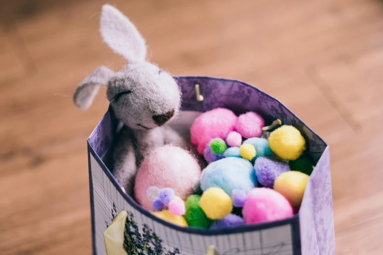 a stuffed animal inside of a container filled with candy