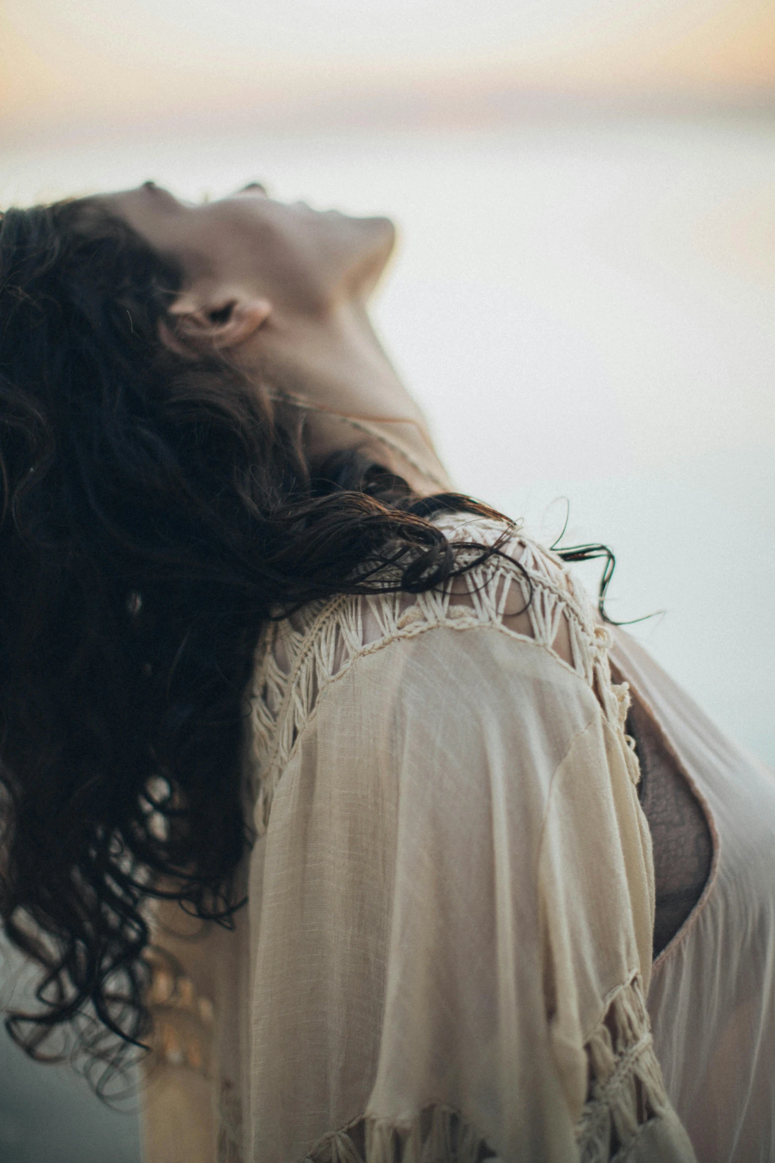 a woman with long hair is laying down