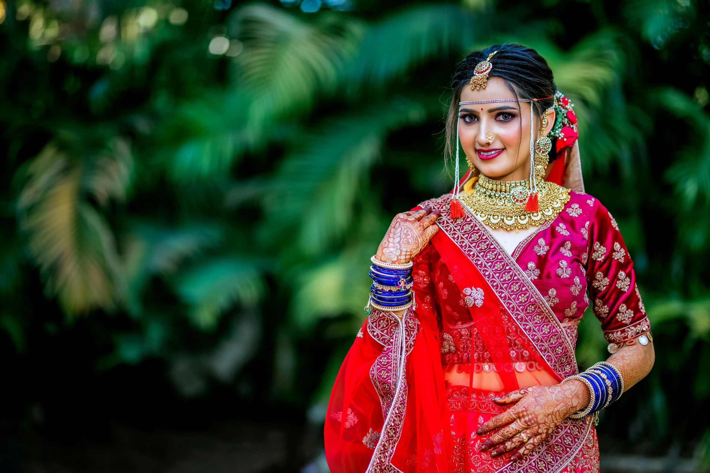 a beautiful young woman dressed in indian attire posing for a po