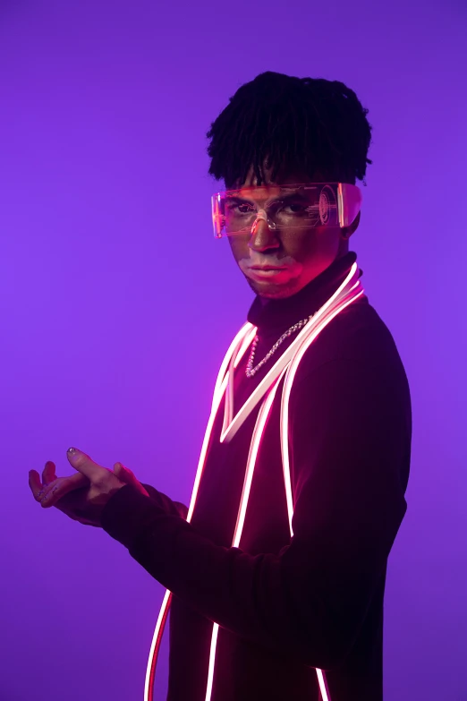 a man standing in front of a bright purple background