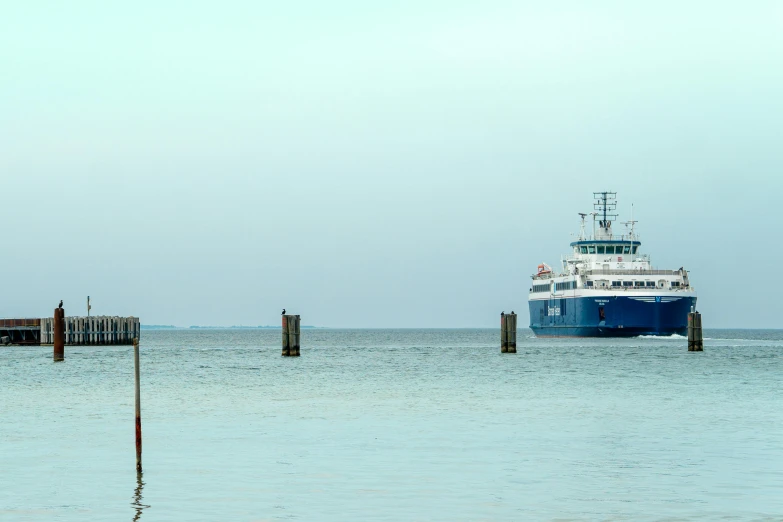 a large ferry is coming to a dock