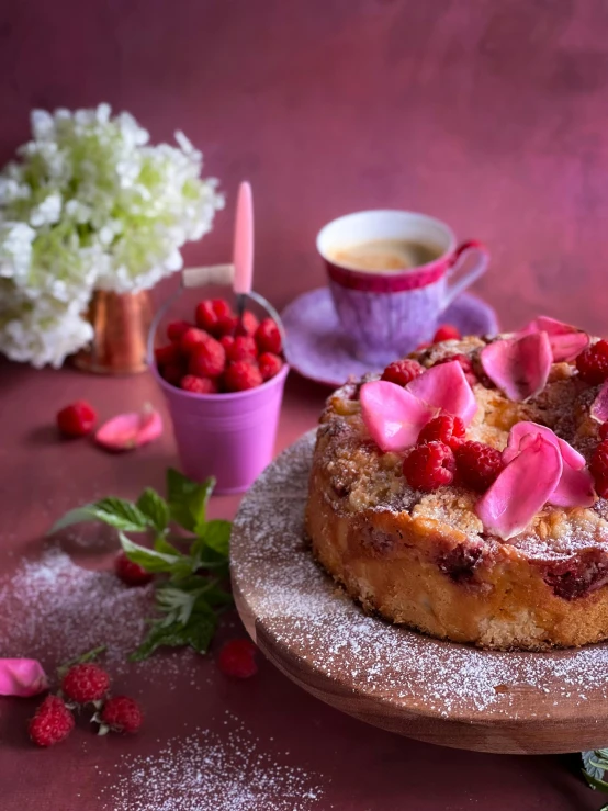 a cake with pink topping sitting on a table