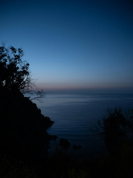 the moon is in the night over the ocean